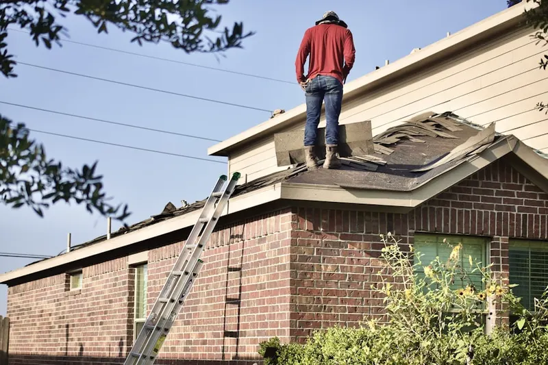 Professional roofer working on a residential roof in Malibu Beach